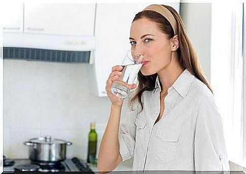 Woman drinking water to expel kidney stones.