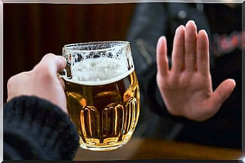 Hand refuses beer mug