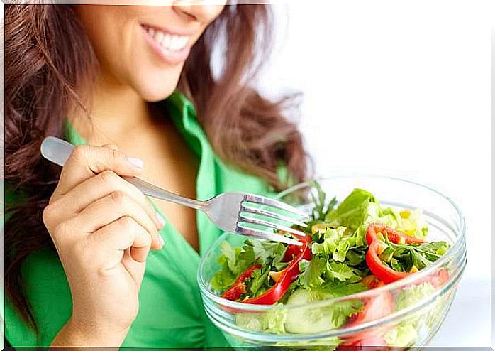 Woman eats salad