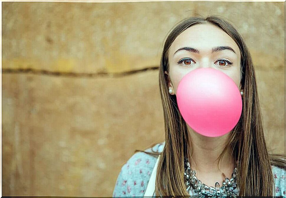 Girl makes bubble with gum