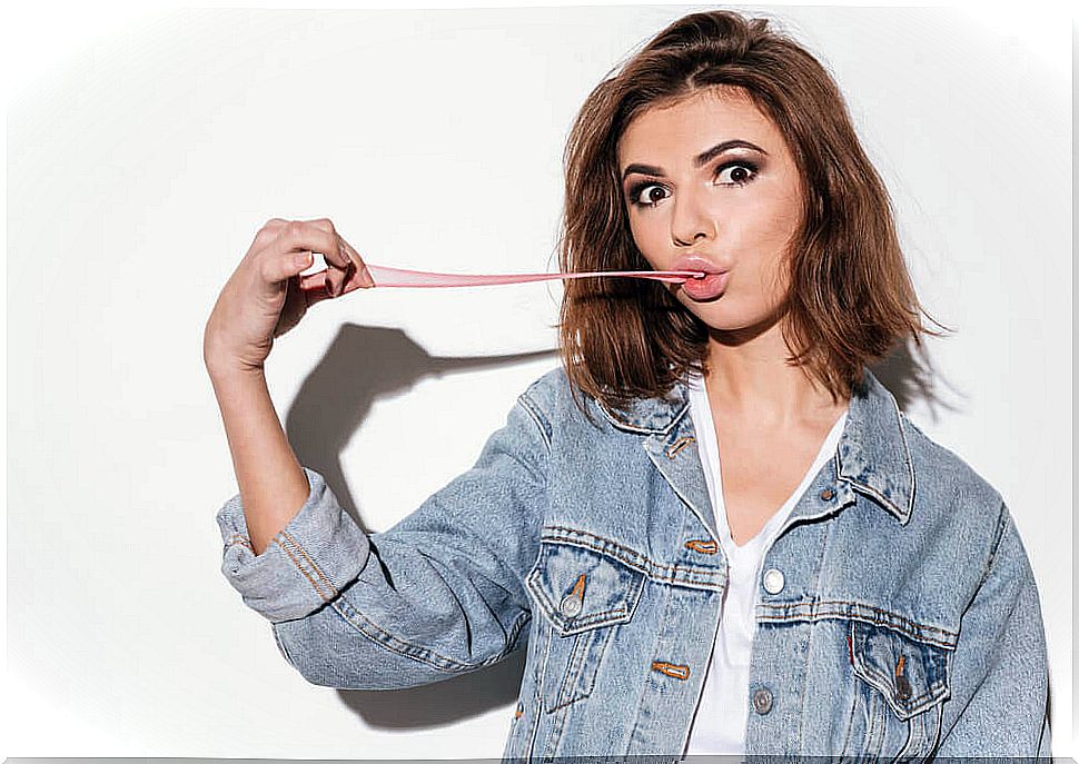 Girl stretches a chewing gum