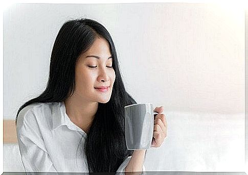 Oriental woman drinks herbal tea.