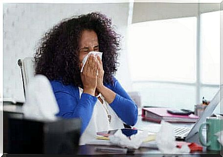 Woman blowing her nose.