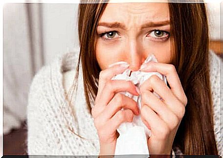 Chilled girl with handkerchief in hand due to flu syndrome.