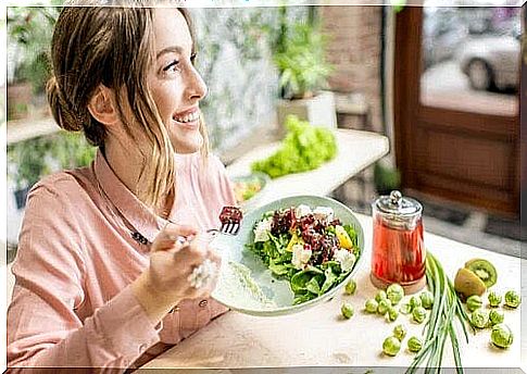 Woman eats healthy and smiles.