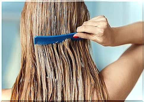 Girl combing her hair with conditioner.