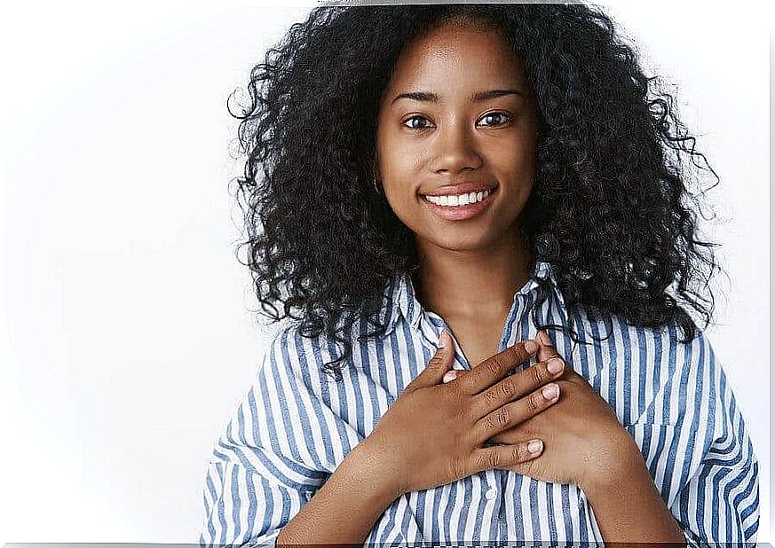 Woman with hand on heart