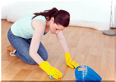 Woman cleans the floor