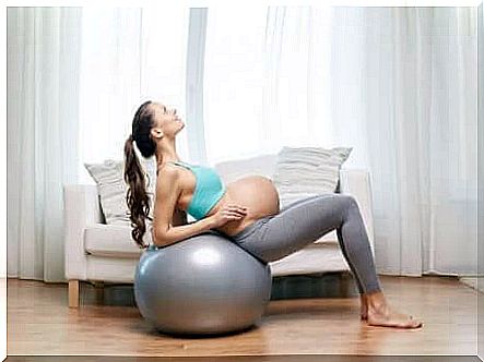 Pregnant woman does exercises on the fitness ball.