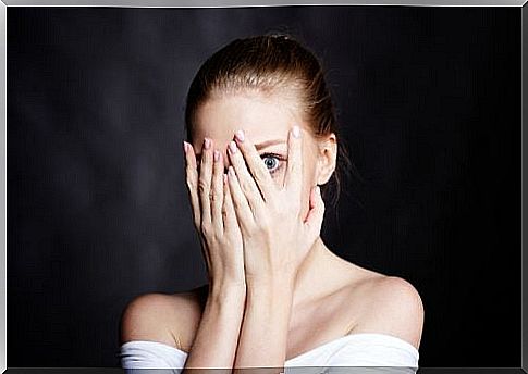 Unresolved issues - Woman who is afraid and hides her face behind her hands